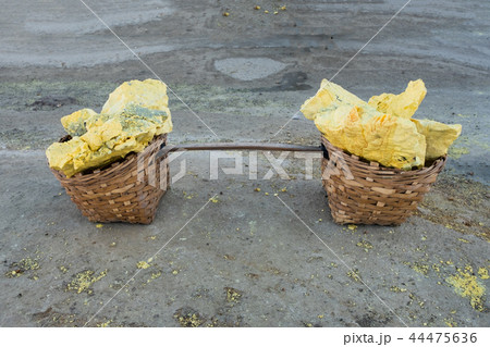 Yellow Sulphur cracked piece on wooden basket 44475636
