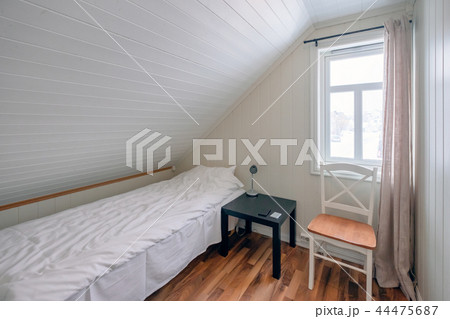 Interior bedroom roof tilted with curtain window Interior bedroom roof tilted with curtain window 44475687