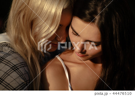 Close up of lesbian couple embracing Close up of lesbian couple embracing 44476510