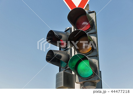 Green traffic lights against blue sky. 44477218