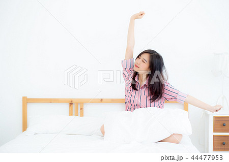 Beautiful asian woman stretch and relax in bed Beautiful asian woman stretch and relax in bed 44477953