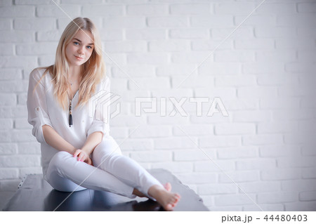 cute blond young adult / portrait of an adult beautiful girl model with blond hair in a happy image cute blond young adult / portrait of an adult beautiful girl model with blond hair in a happy image 44480403