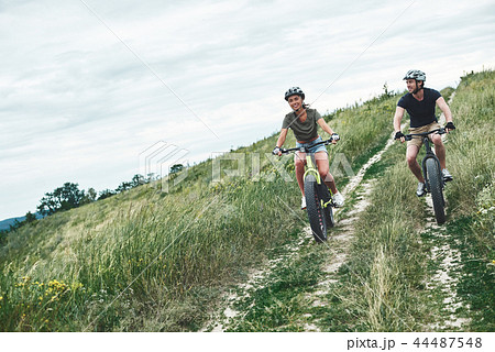 Young couple are cycling on fatbikes and in helmets 44487548