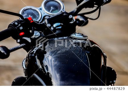 Water droplets on motorcycle fuel tank 44487829