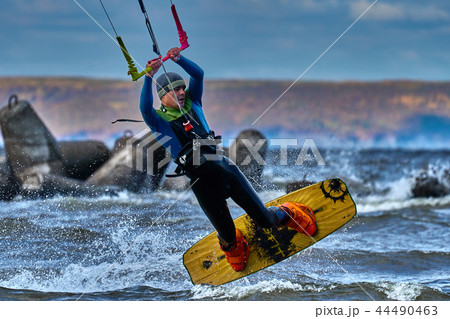 A male kiter slides on the surface of the water.  44490463