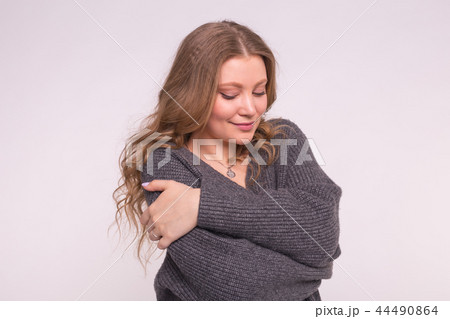 Fashion, style and people concept - portrait of a beautiful young woman with a gentle smile over 44490864