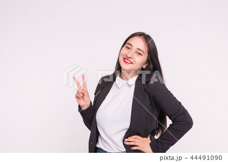 Beautiful young asian woman showing Victory Sign on white background with copy space Beautiful young asian woman showing Victory Sign on white background with copy space 44491090