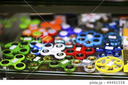 Hand spinners or fidgeting spinners. Many types and shapes of spinners with prices put on the black Hand spinners or fidgeting spinners. Many types and shapes of spinners with prices put on the black 44491558