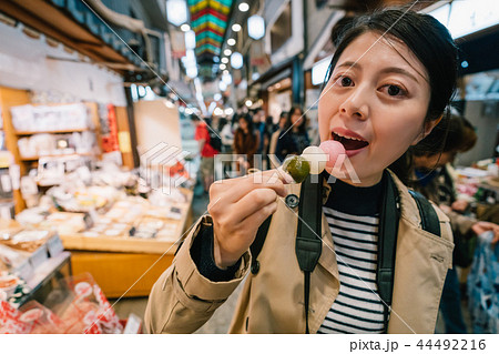 an elegant female traveler eating Dango 44492216