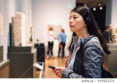 lady wearing earphone hear the voice guide lady wearing earphone hear the voice guide 44492224