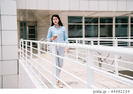 an elegant lady walking through the bridge 44492234