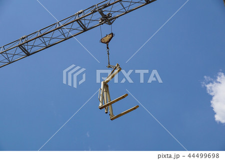 Crane lifting Pallet .Blue sky on background Crane lifting Pallet .Blue sky on background 44499698