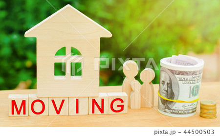 family stands near the miniature house with 44500503