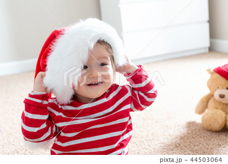 Toddler boy with a Santa hat at Christmas time 44503064