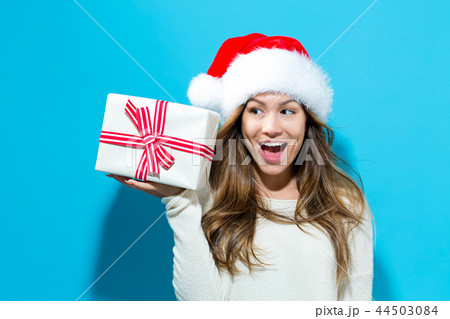 Young woman holding a Christmas gift 44503084