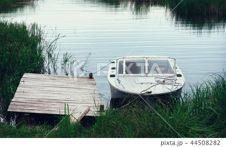 Boat At The Pier Among The reeds In A River Bay 44508282