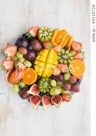 Rainbow fruits berries on white wood 44510726