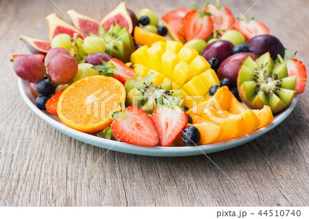 Rainbow fruits on grey wood 44510740