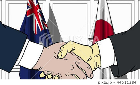 Businessmen or politicians shaking hands against flags of Australia and Japan. Meeting or 44511384