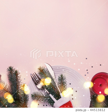 Fir branches and cutlery in Santa hat 44513812