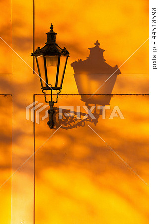 The retro street light on the wall at sunset. The retro street light on the wall at sunset. 44518598