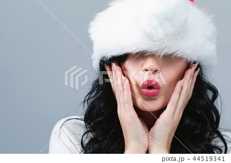 Woman with a Santa hat pulled over her eyes 44519341