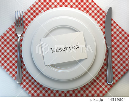 Reserved card on a restaurant table setting 44519804
