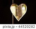 Heart carved in dark wooden wall texture, with bokeh background 44520282