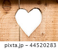 Heart carved in dark wooden wall texture, with bokeh background isolated 44520283