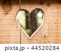 Heart carved in wooden wall texture, with bokeh background 44520284