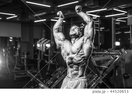 Handsome model muscle man abs workout in gym 44520653