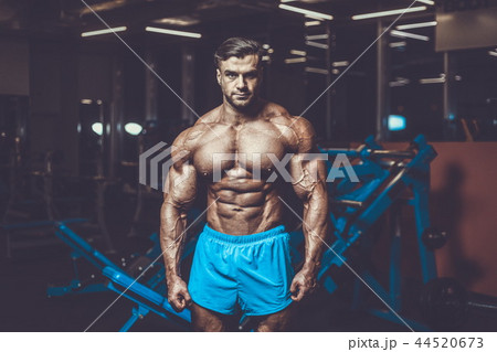 Handsome model muscle man abs workout in gym Handsome model muscle man abs workout in gym 44520673