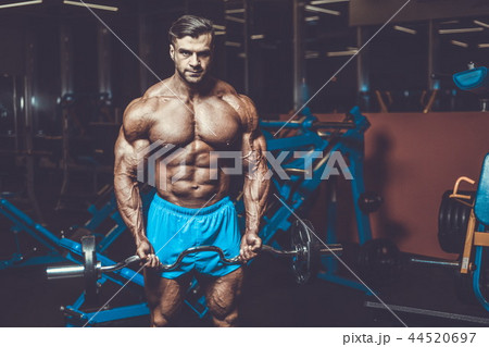 Handsome model muscle man abs workout in gym Handsome model muscle man abs workout in gym 44520697