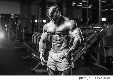 Handsome model muscle man abs workout in gym 44521656