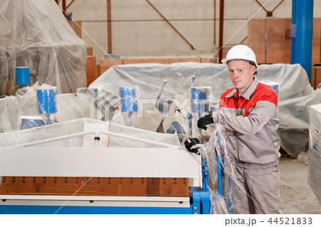 manufacture workshop. Worker unpacks the machine in the warehouse. the production of ventilation and 44521833