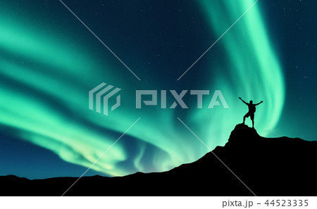 Northern lights, silhouette of happy man. Aurora Northern lights, silhouette of happy man. Aurora 44523335