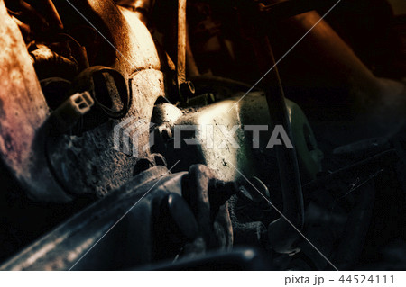 rusty old motorcycle under low light 44524111