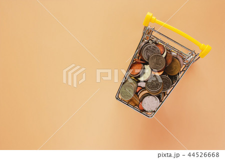 Full of coins in mini shopping cart or trolley Full of coins in mini shopping cart or trolley 44526668