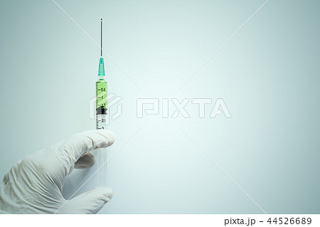 Hand holding syringe injection on white background Hand holding syringe injection on white background 44526689
