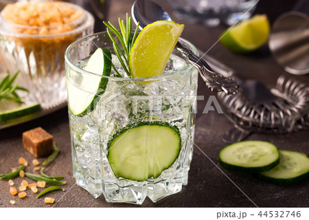 Close up retro glass jars of lemonade with cucumber and mint on wooden table Close up retro glass jars of lemonade with cucumber and mint on wooden table 44532746