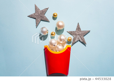 Blank french fries box with white New Year's balls on a blue paper background, flat lay with copy 44533028