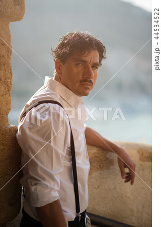 Portrait of Man with Moustaches Leaning at the Wall 44534522