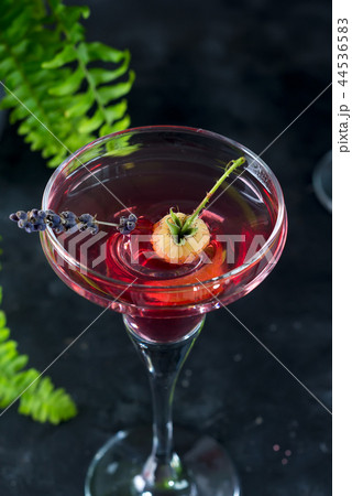 Delicious cocktails with campari, gin, vermouth, and a berries. Refreshing summer drink on stone or 44536583