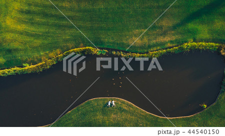 Frame shot from a drone a couple holding hands 44540150