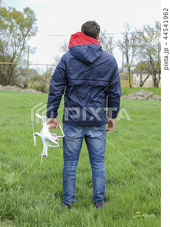 A man with a quadrocopter in his hands. White kvadrokopter prepare for flight A man with a quadrocopter in his hands. White kvadrokopter prepare for flight 44541962
