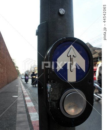 Arrow sign crosswalk button in the city 44542065