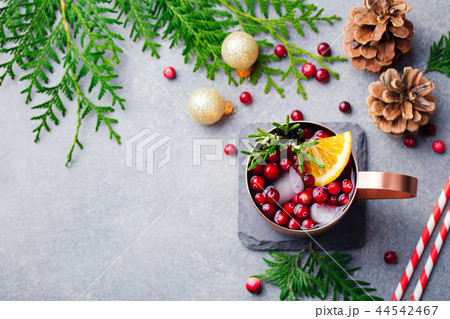 Christmas Moscow mule, holiday drink in a copper mug. Grey stone background. Top view. Copy space. Christmas Moscow mule, holiday drink in a copper mug. Grey stone background. Top view. Copy space. 44542467