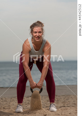 Young sporty woman training with kettle bell 44542512