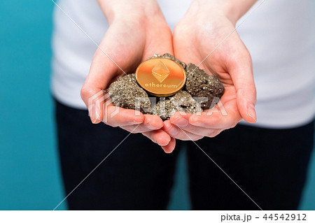 Woman with a ethereum with raw gold nuggets Woman with a ethereum with raw gold nuggets 44542912