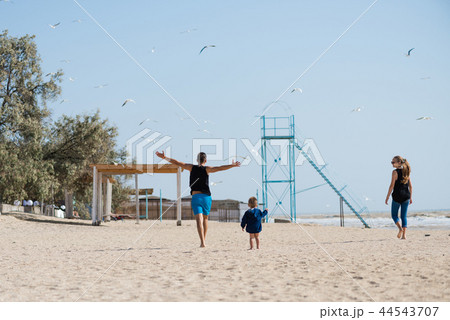 Happy family on the beach from back 44543707